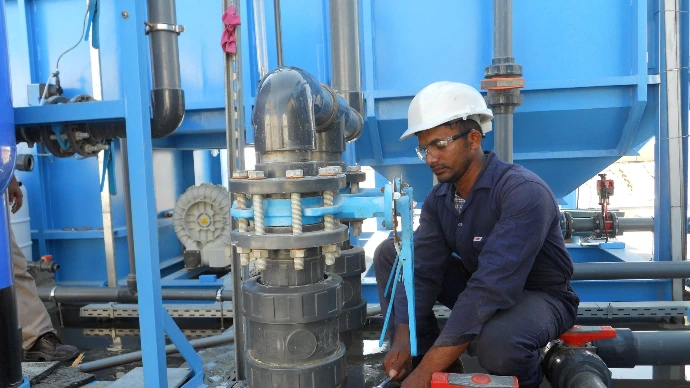 Image of a man working on a pump