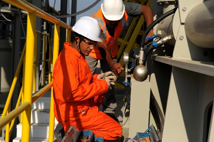 Images of two Aaron Tech employees working in full safety gear
